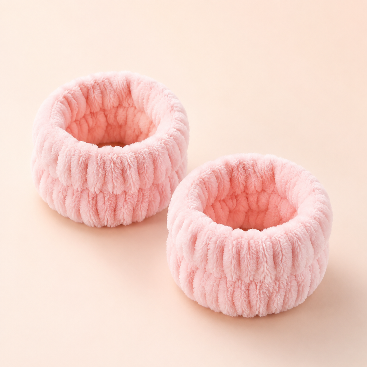 Pair of CJ Beauty pink wrist wash bands